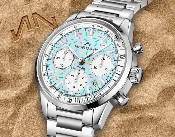 NORQAIN Freedom chronograph with a turquoise dial and stainless steel bracelet.