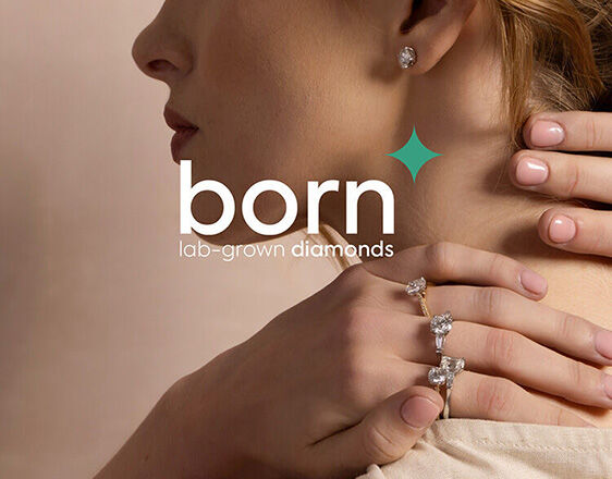 Woman wearing Born lab-grown diamond engagement rings and earrings, sustainable fine jewellery collection