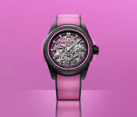 NORQAIN skeleton watch with a pink strap against a pink background.
