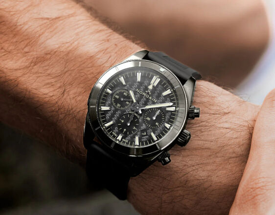 NORQAIN Adventure Sport Chrono 44mm watch with black DLC case and black rubber strap on wrist