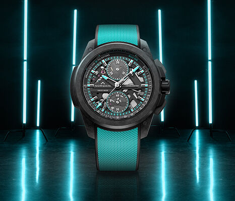 NORQAIN skeleton chronograph with a turquoise strap and illuminated backdrop.