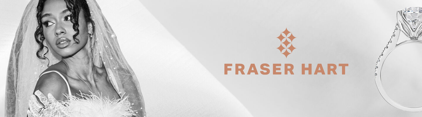 Luxury diamond engagement ring beside a bride in a veil, showcasing Fraser Hart engagement rings.